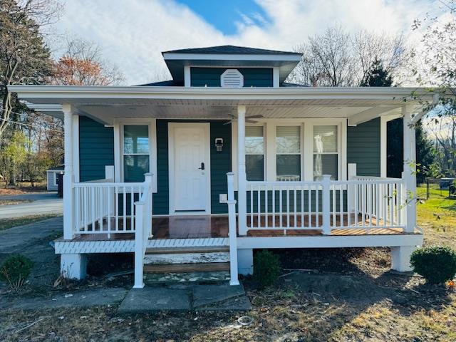 a view of a house with a yard and deck