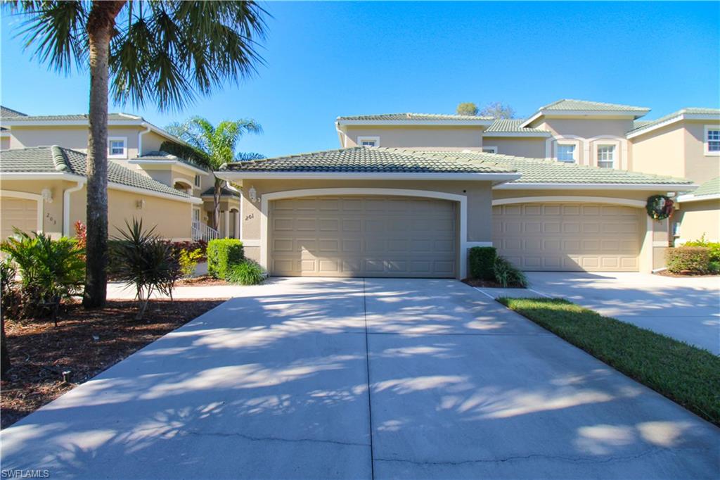 a front view of a house with a yard and a garage