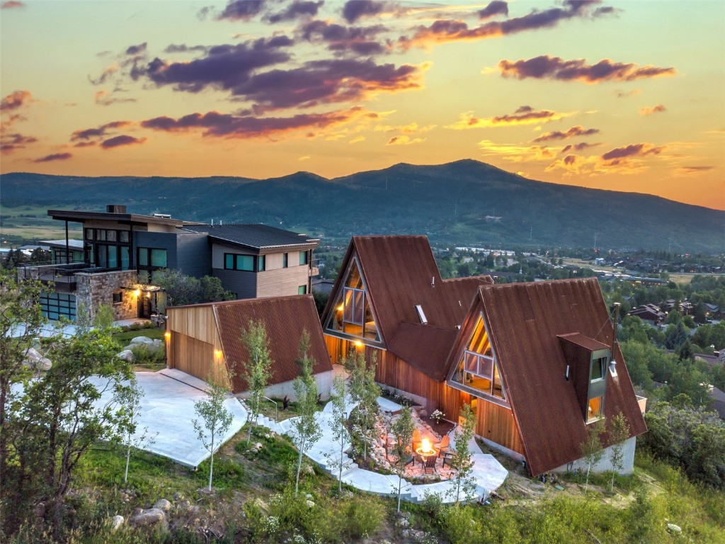 an aerial view of a house with yard swimming pool and outdoor seating