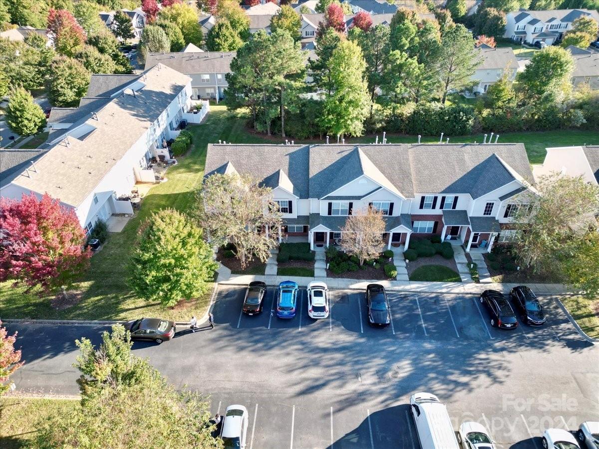 an aerial view of a house with garden space and a patio