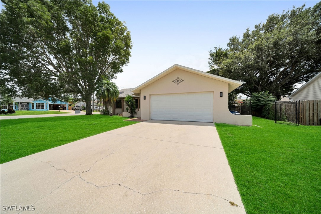 a front view of house with yard and green space