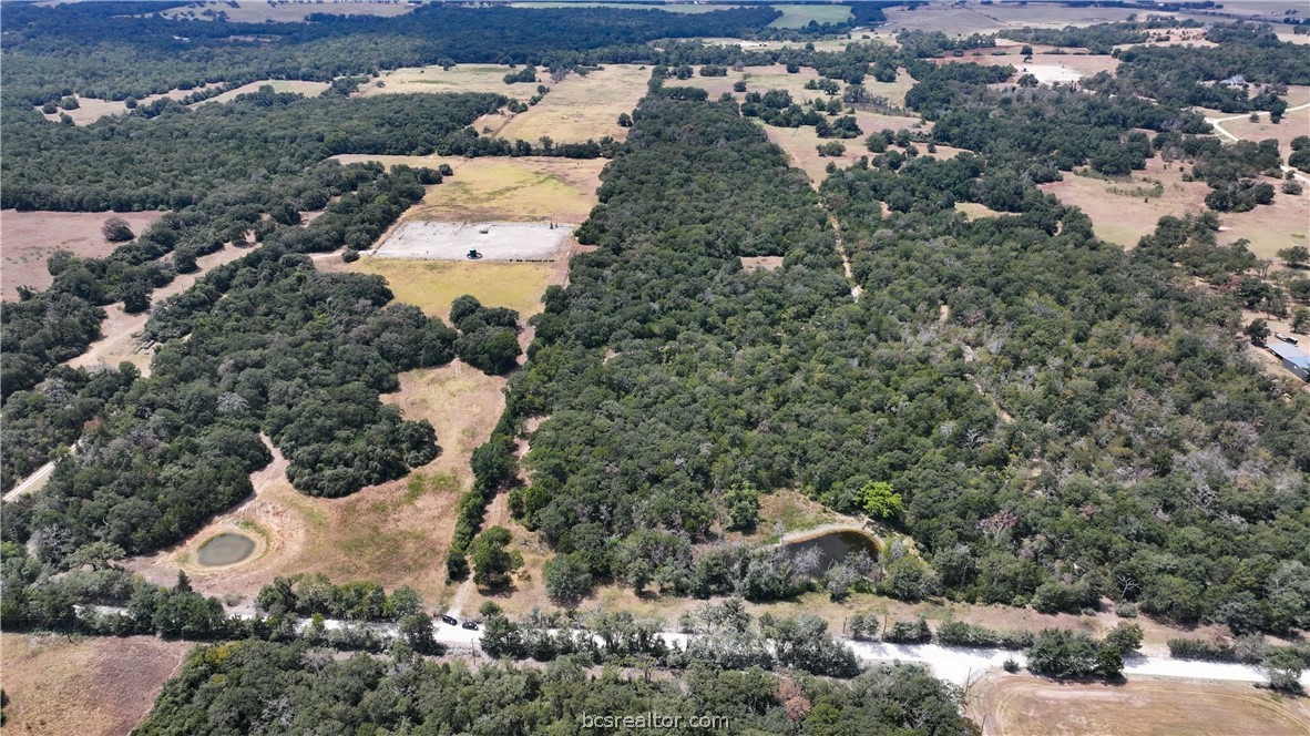 an aerial view of a house with a yard and mountain