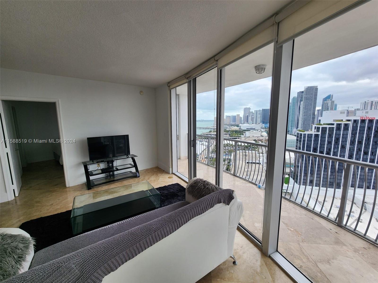 a bedroom with furniture and a flat screen tv