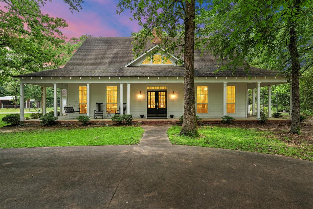 a front view of house with yard and green space