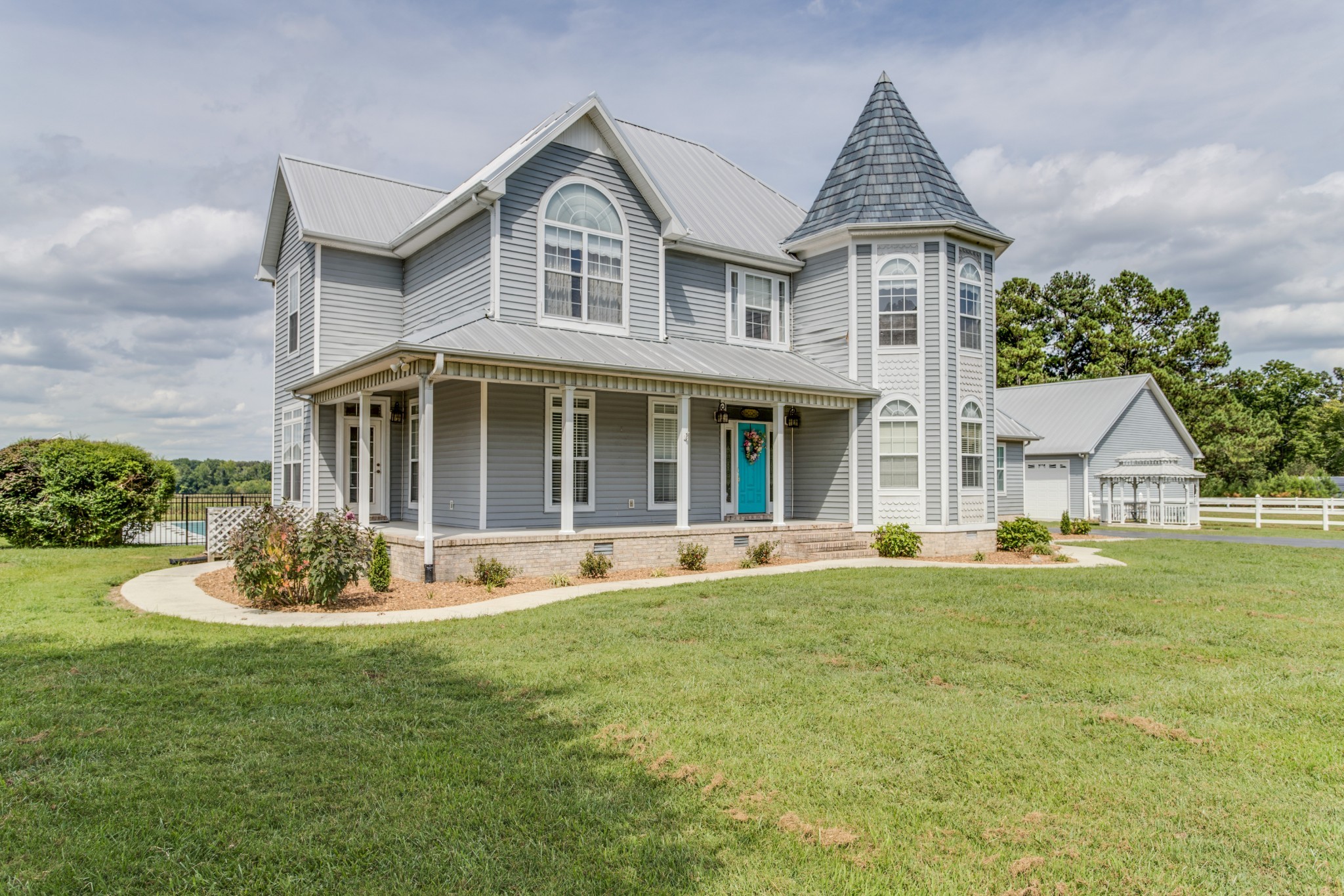 a front view of a house with a garden and porch