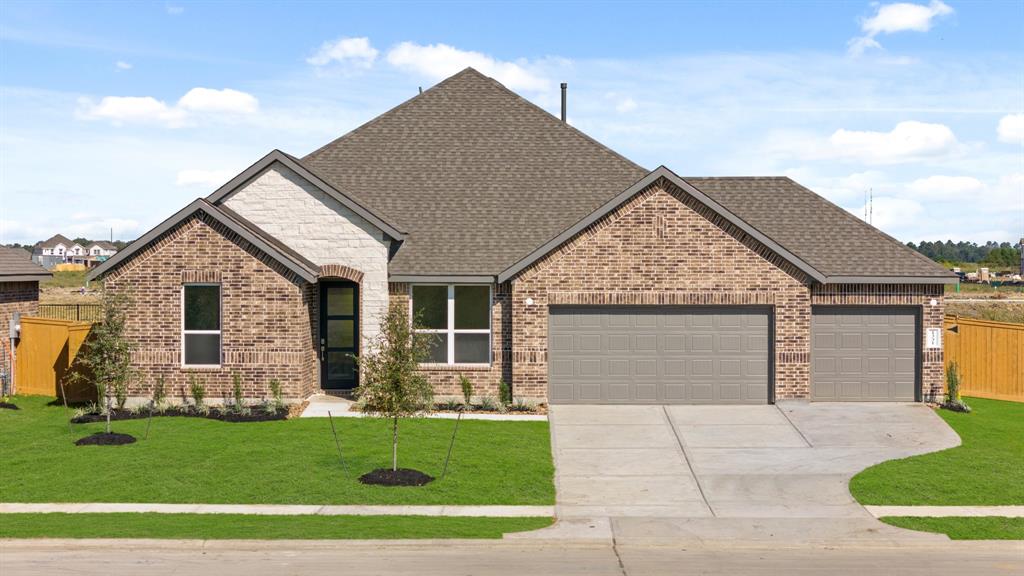 a front view of house with garage and yard