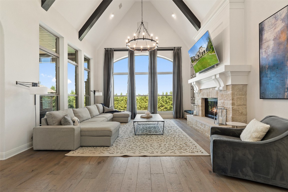 a living room with fireplace furniture and a large window