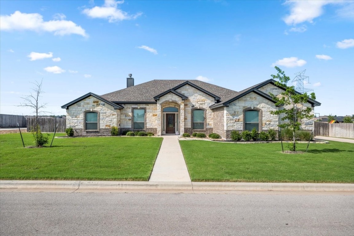 a front view of a house with a yard