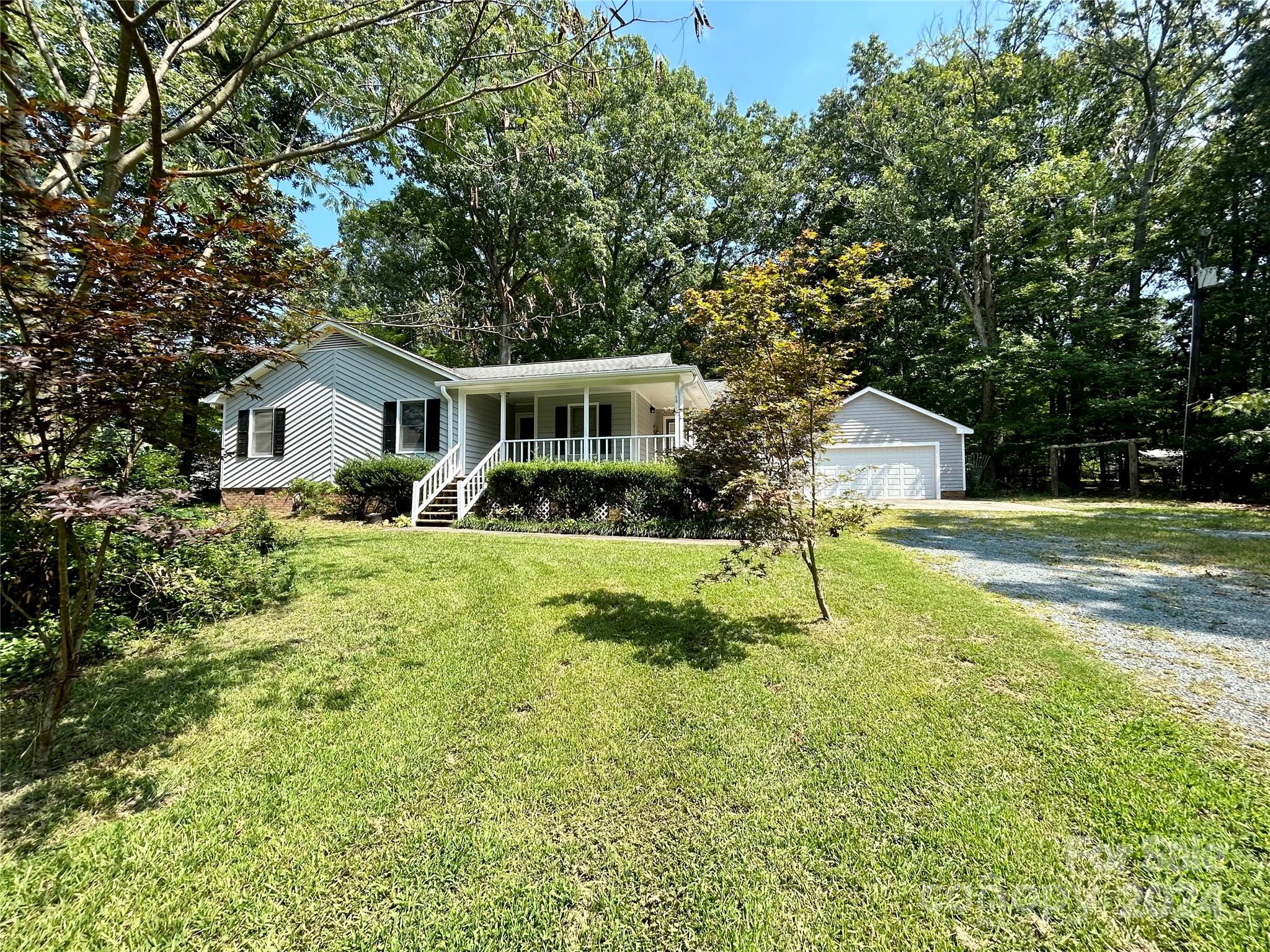 a view of house with a yard