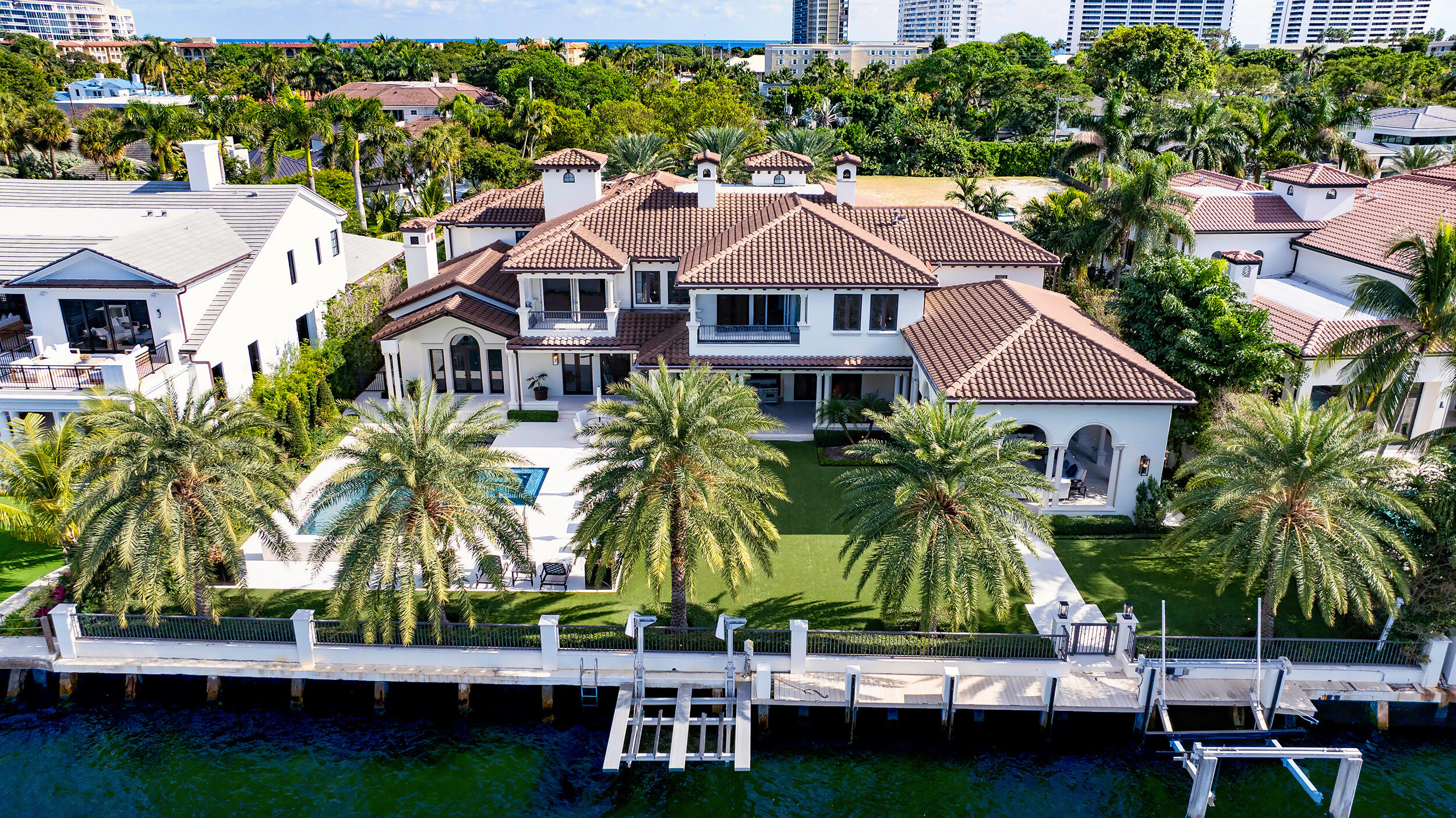 an aerial view of multiple houses with a yard