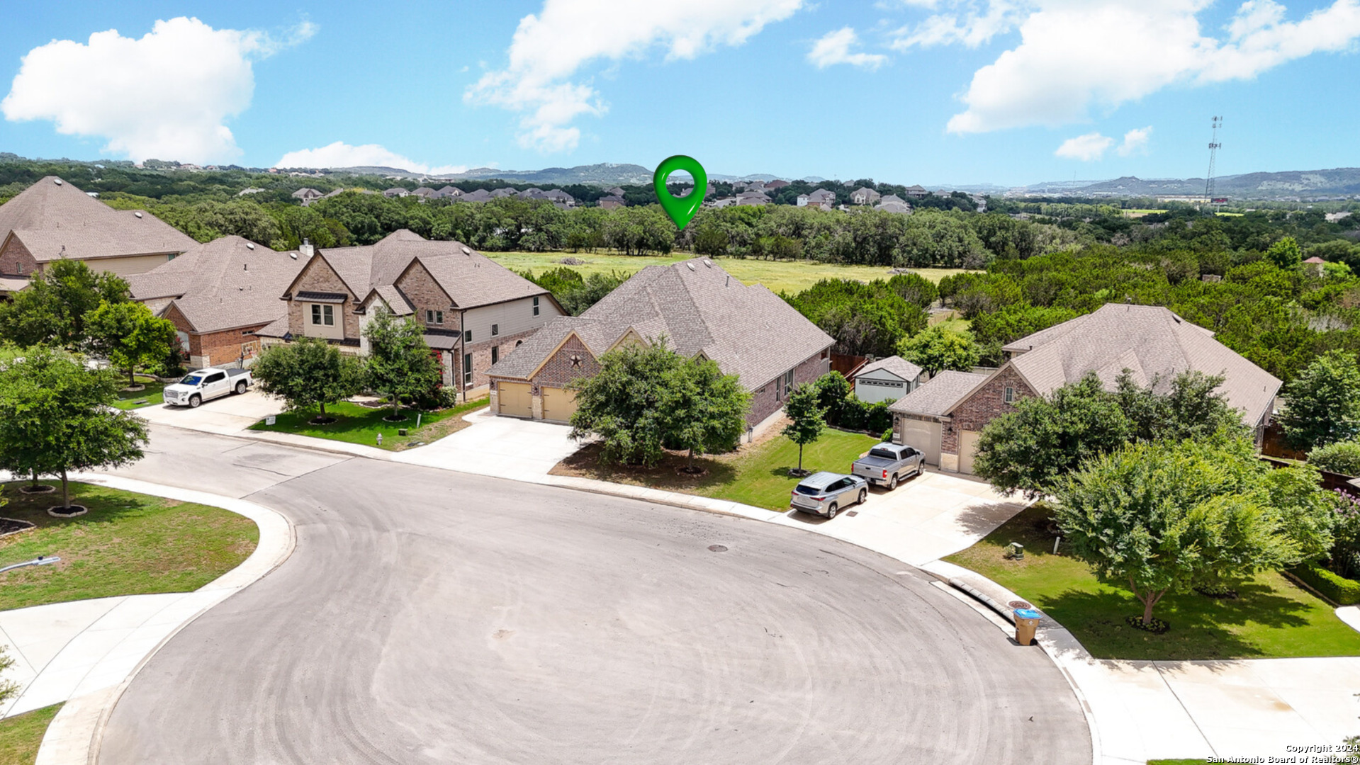 an aerial view of a house with a garden and lake view