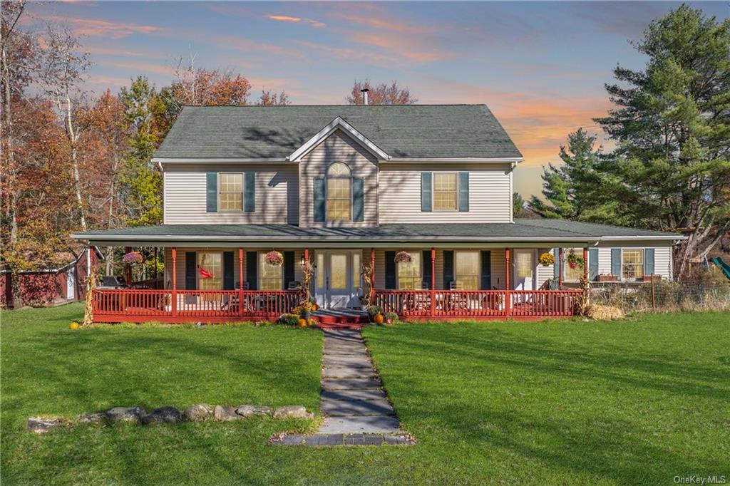 Farmhouse with a yard and a porch