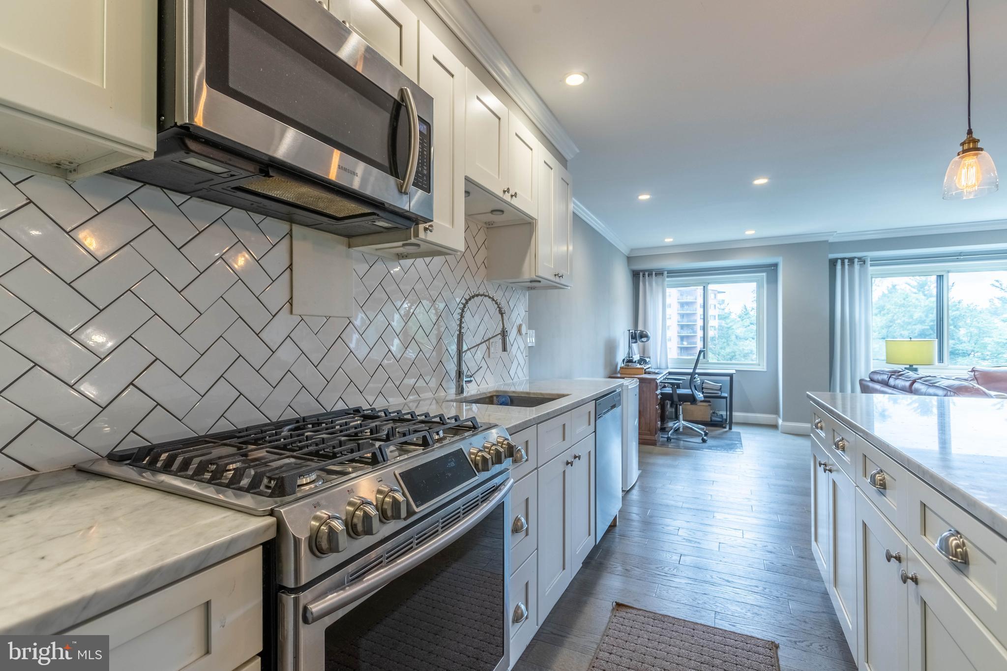 a kitchen with stove and cabinets