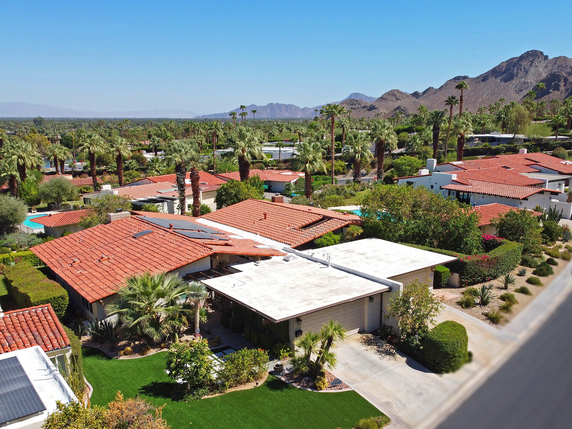 an aerial view of a houses with a swimming pool