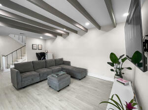 a living room with furniture potted plant and a window