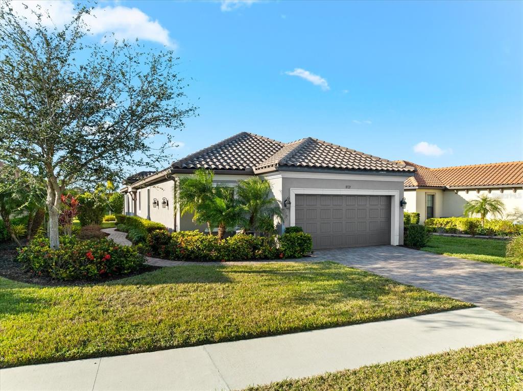 a front view of a house with a yard and garage