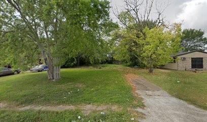 a big yard with swimming pool and green space