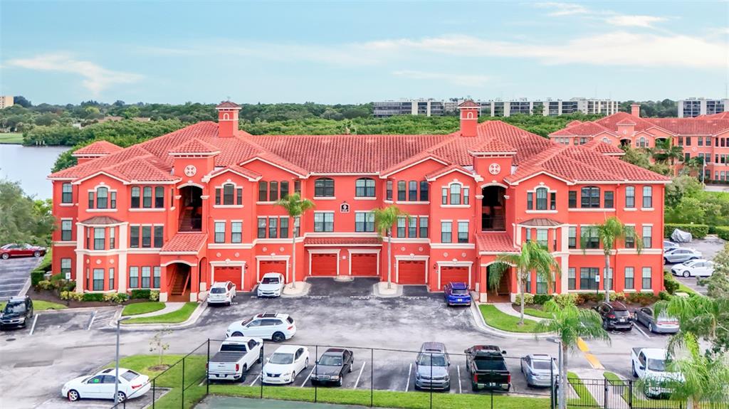 an aerial view of residential houses with outdoor space and parking