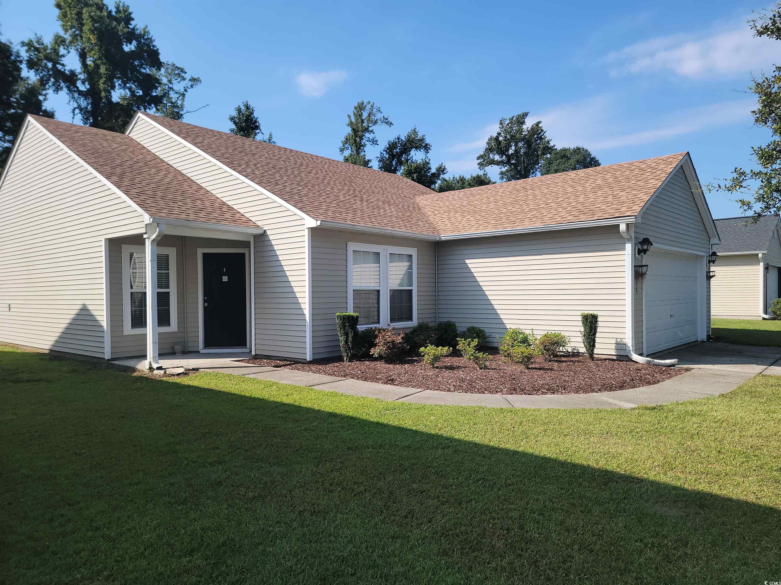 Single story home featuring a garage and a front l