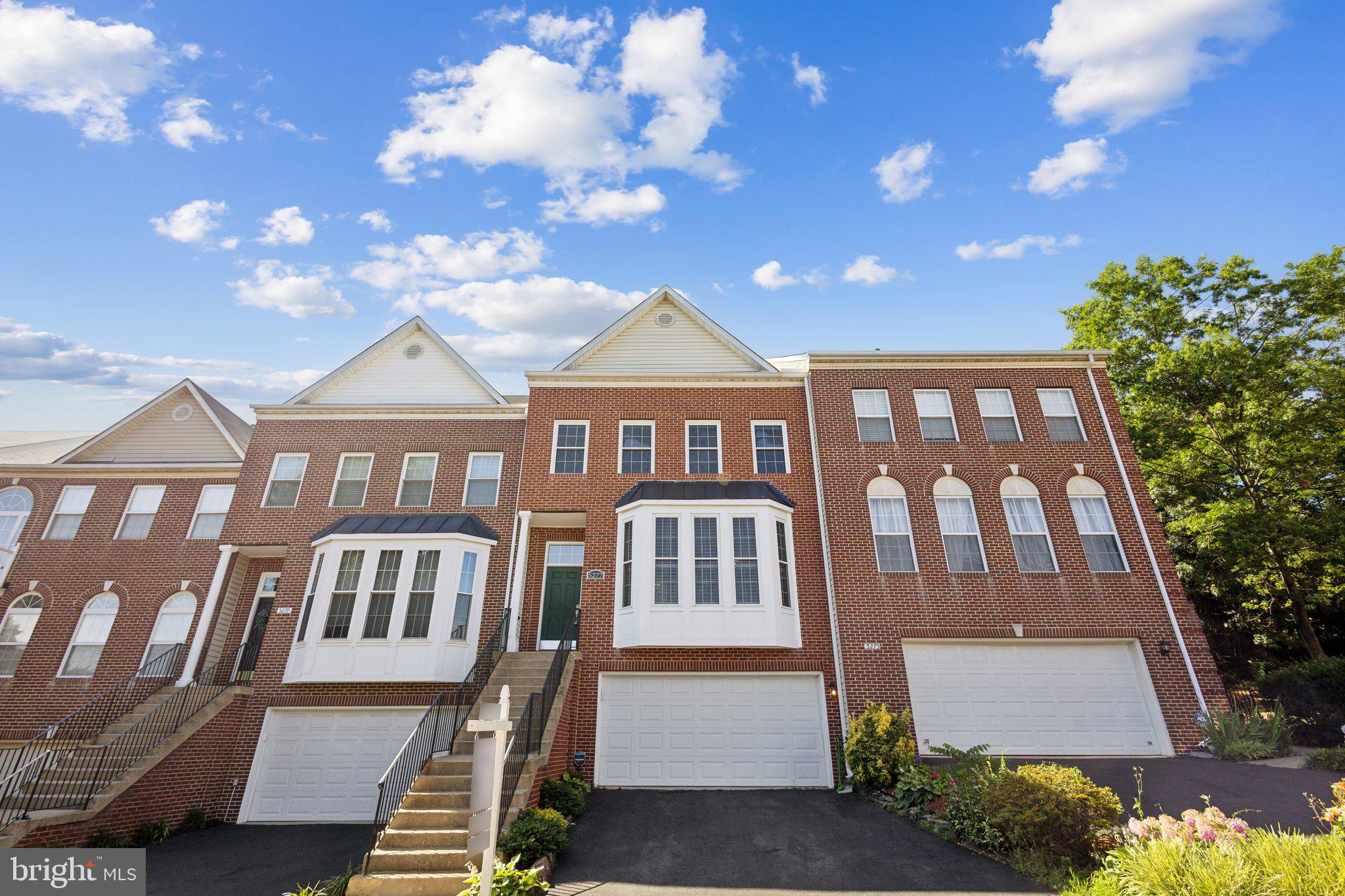 a front view of a residential apartment building with a yard