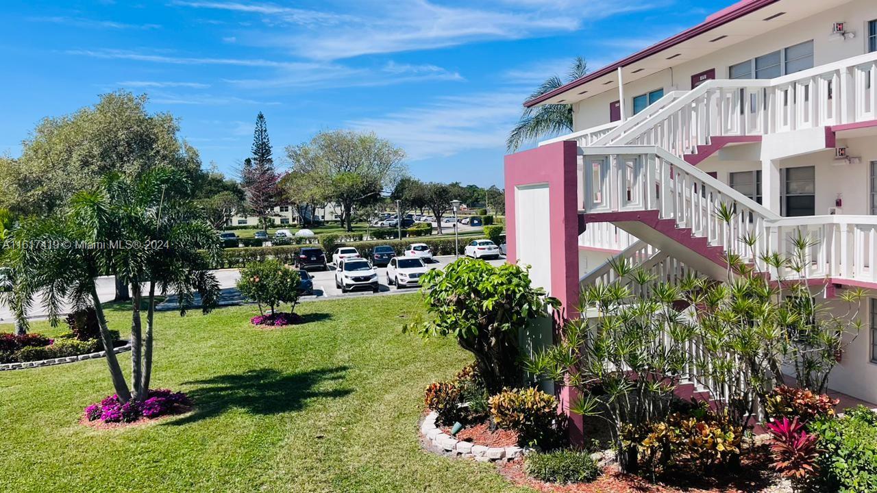 a view of a multi story building with a yard