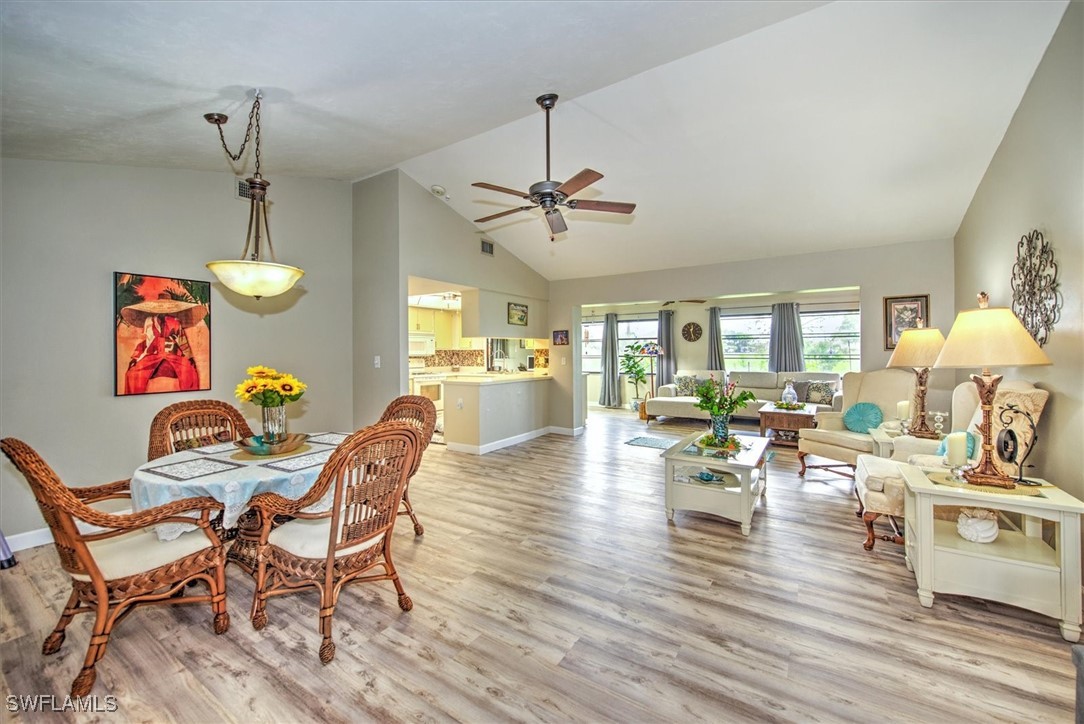 a view of a dining room with furniture wooden floor and chandelier