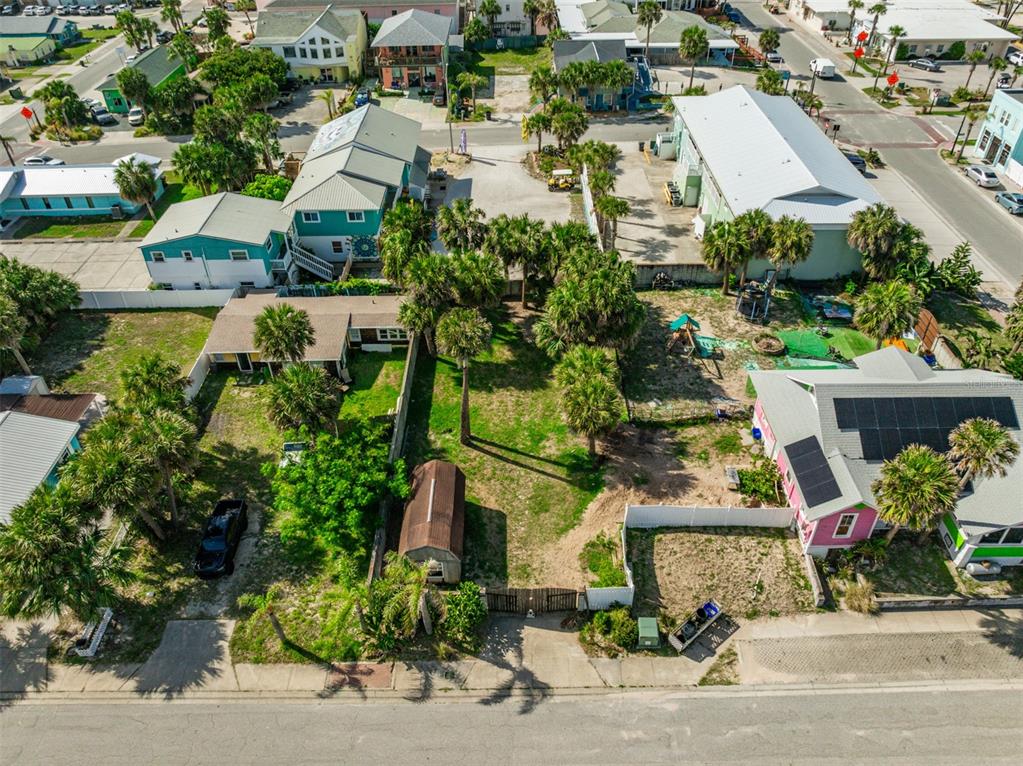 an aerial view of a houses with street