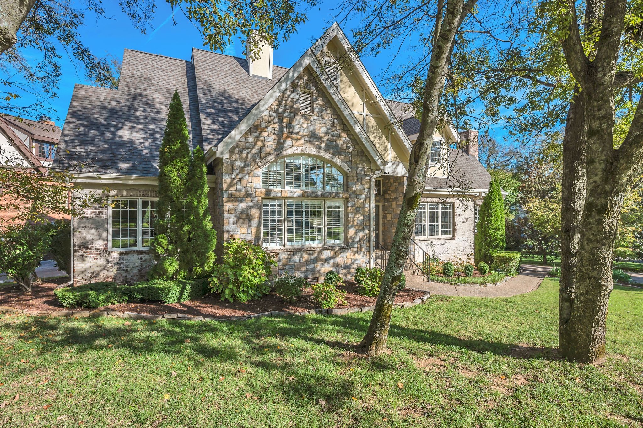 Welcome to 1634 S. Observatory Drive! This stunning home offers exceptional curb appeal with its beautifully landscaped front yard and charming, tudor stone architecture.