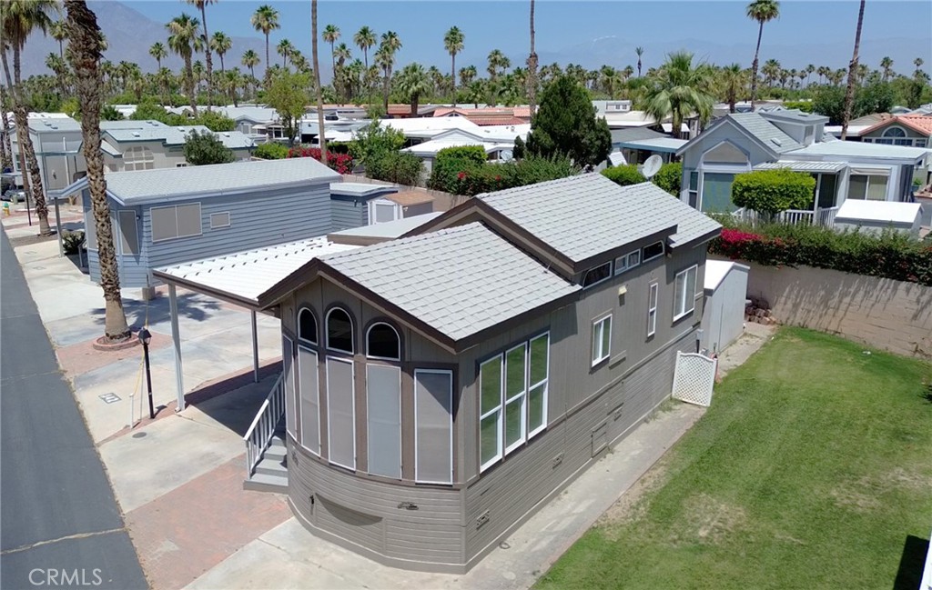 an aerial view of a house with a yard