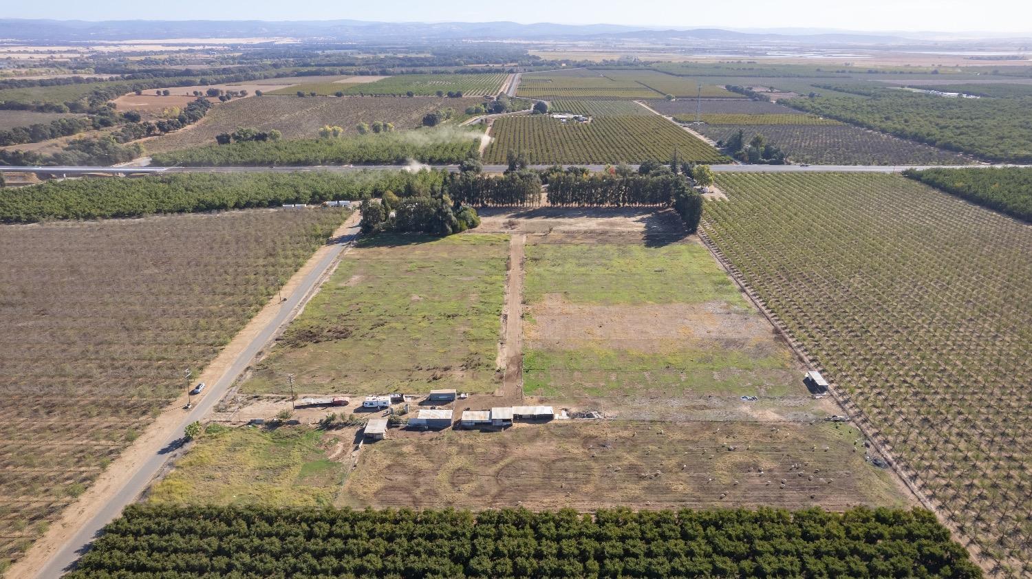 an aerial view of a house with a yard and lake view