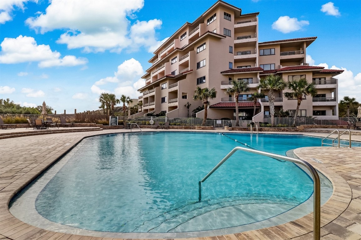 a view of a swimming pool with a yard