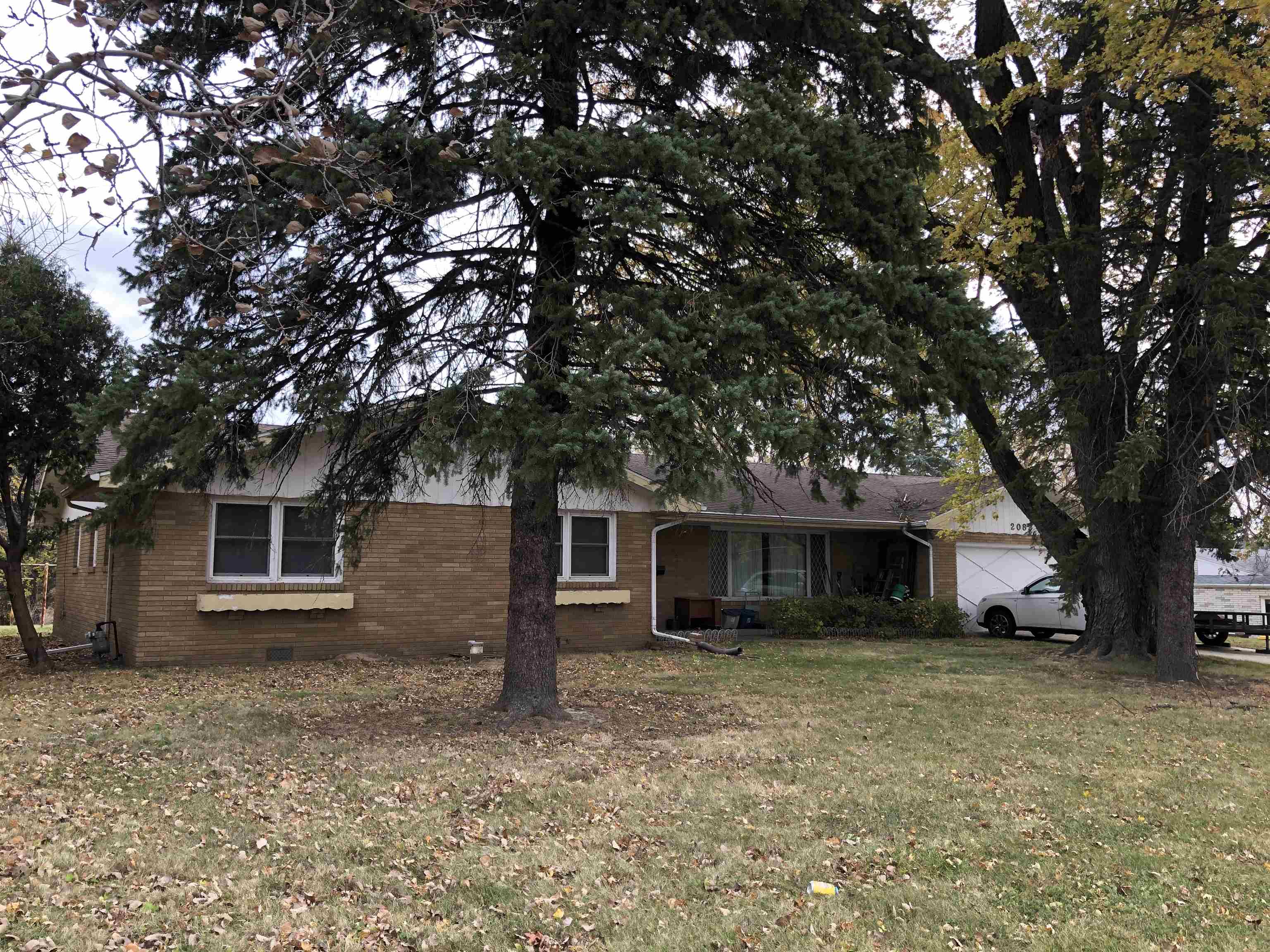 front view of a house with a tree