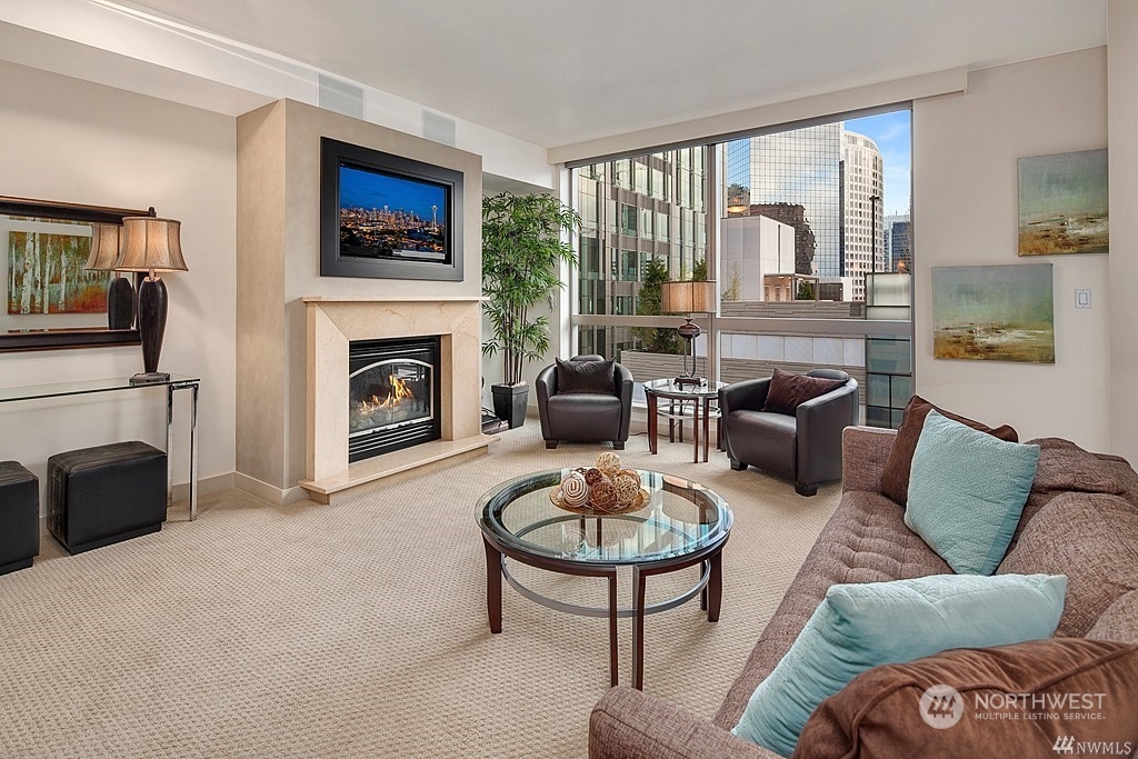 a living room with furniture a fireplace and a flat screen tv