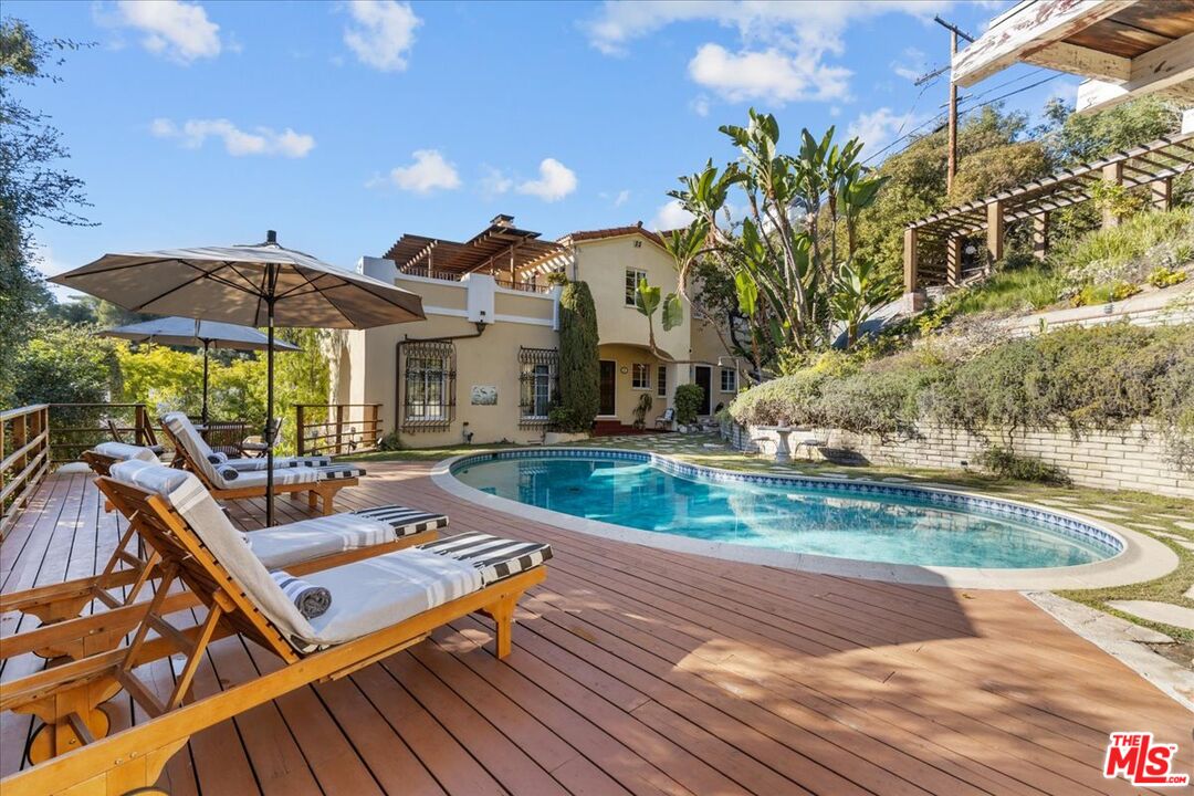 a view of a patio with a table and chairs under an umbrella