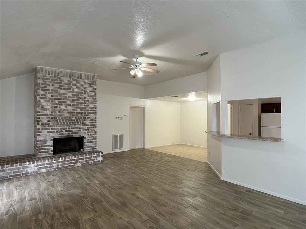 brick, wood-burning fireplace in living room