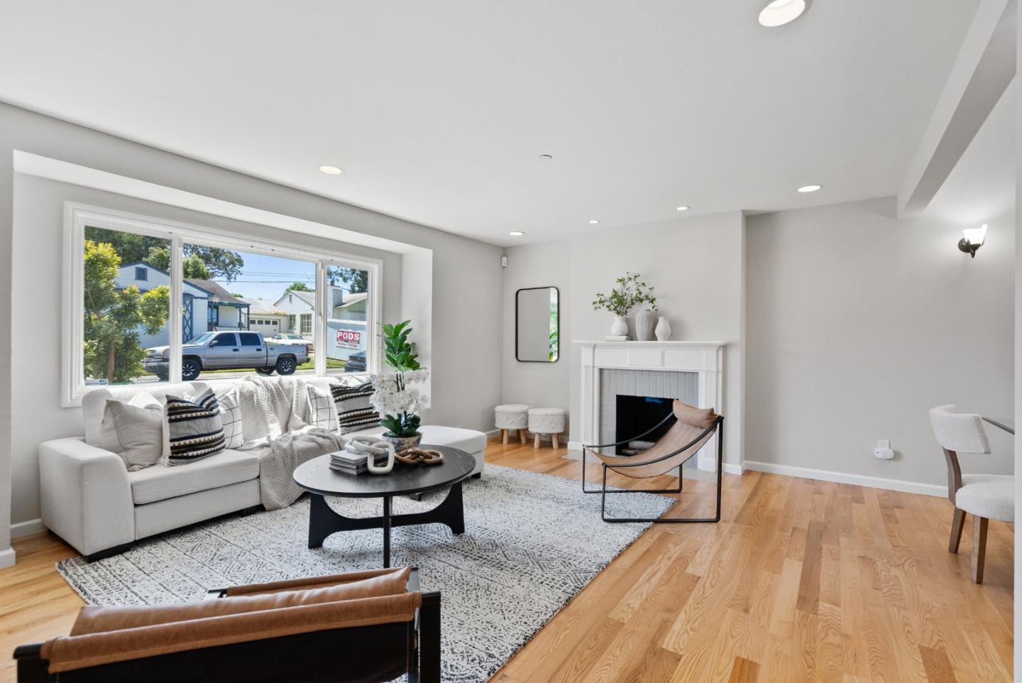 a living room with furniture a fireplace and a potted plant