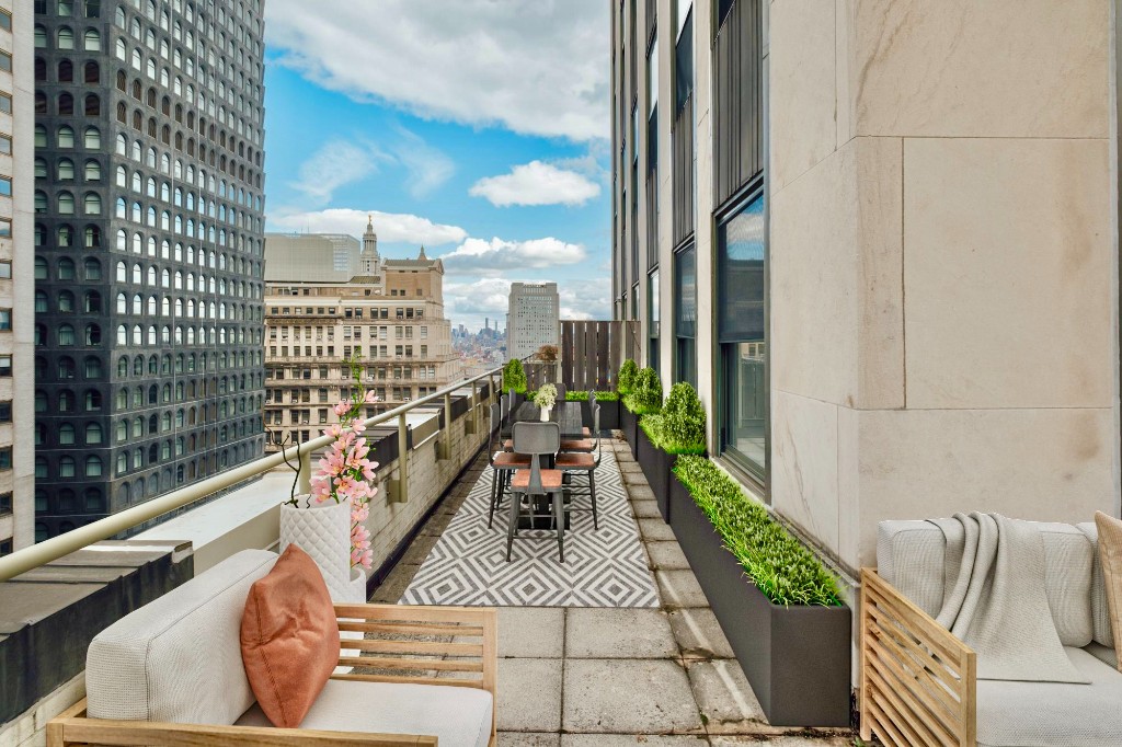 a balcony with furniture and a floor to ceiling window