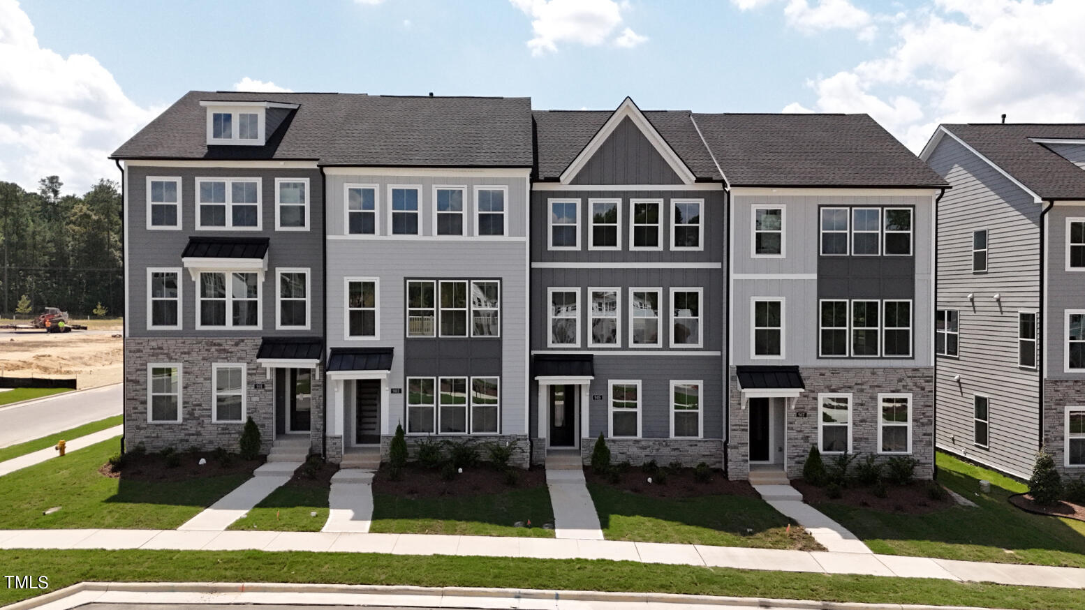 a front view of a residential apartment building with a yard