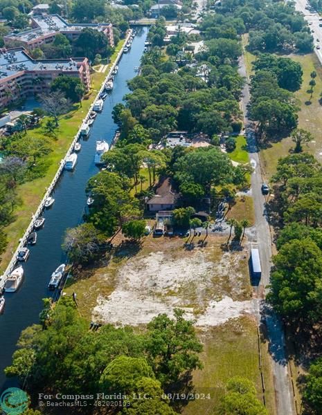 an aerial view of residential houses with outdoor space and trees