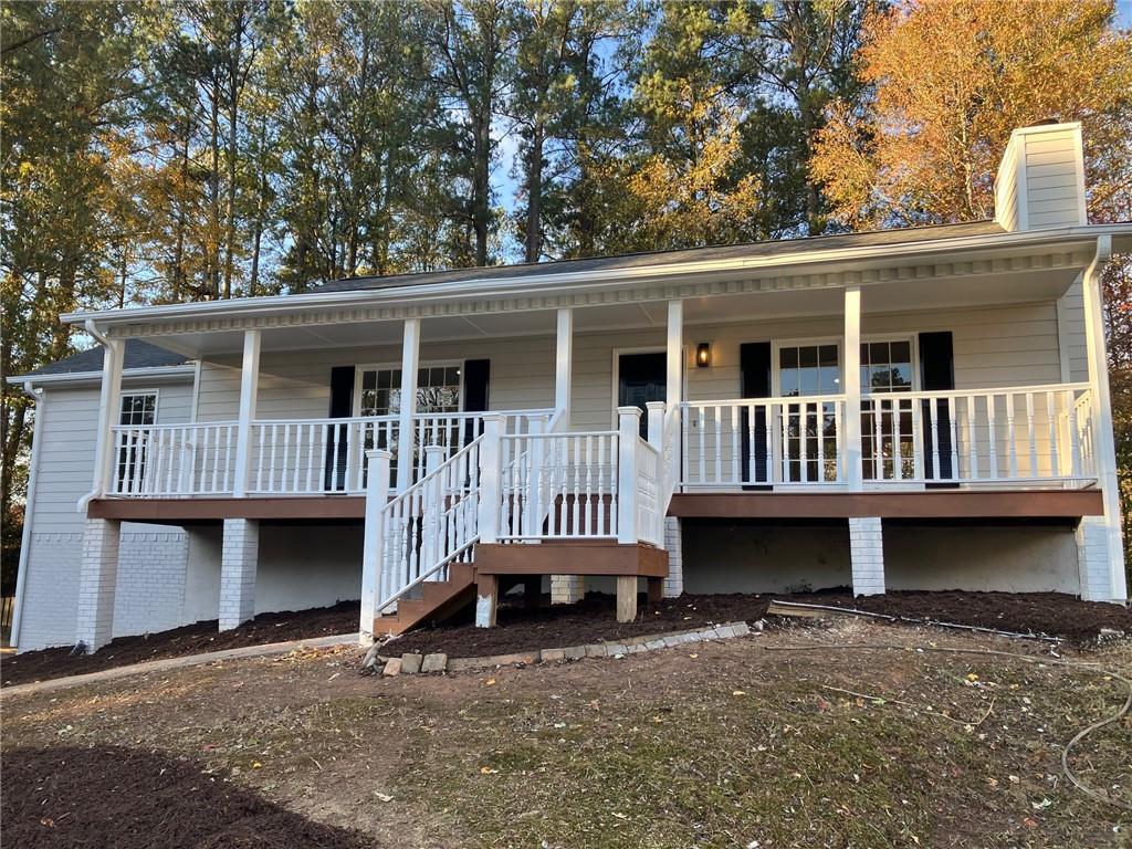 a front view of a house with yard deck and barbeque oven