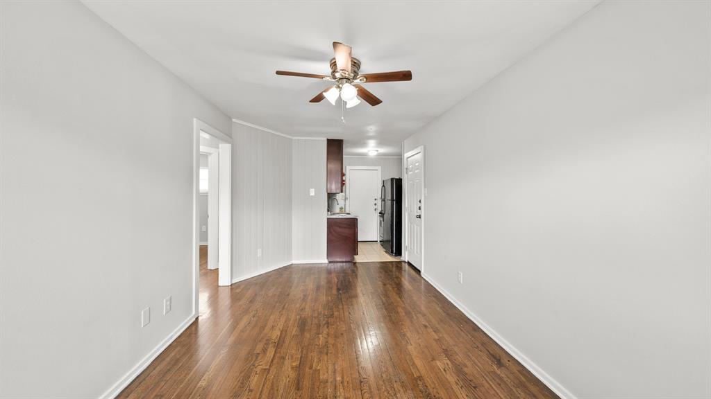 a view of a big room with wooden floor a ceiling fan and closet