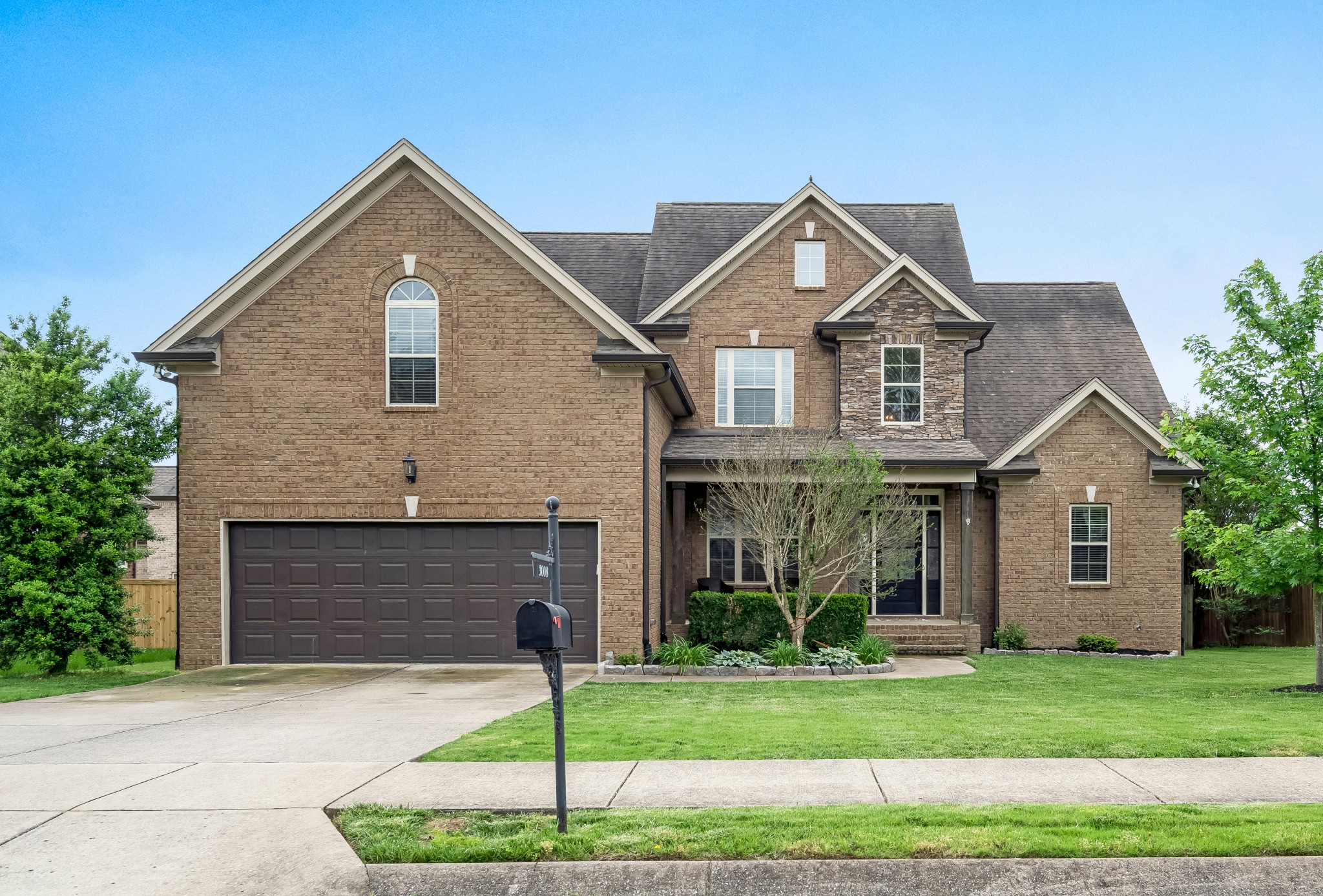 a front view of a house with a yard and garage