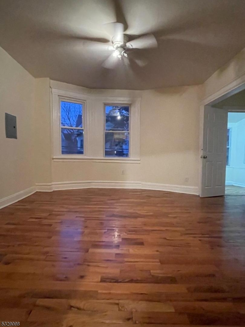 a view of room with hardwood floor and ceiling fan