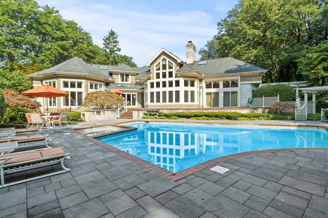 View of large pool deck and inground swimming pool