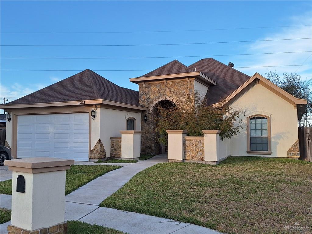 a front view of a house with a yard and garage