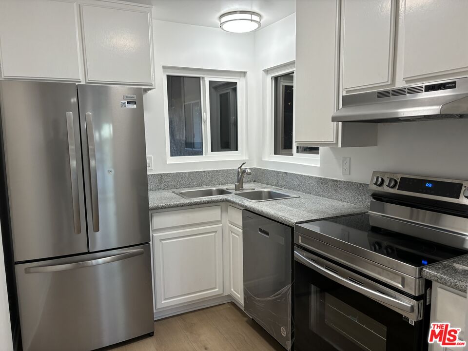 a kitchen with a refrigerator and a sink