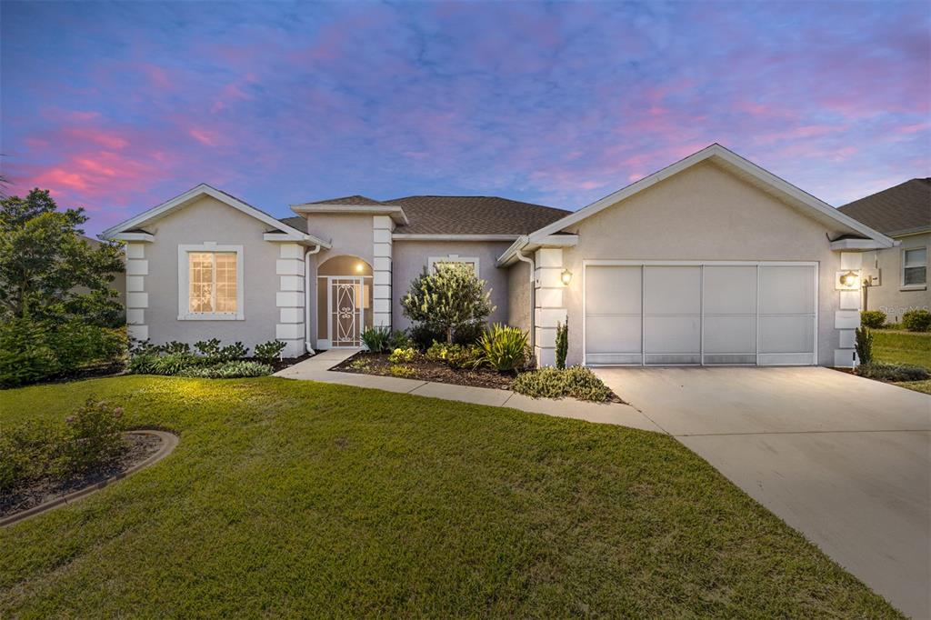 a front view of a house with a yard and garage