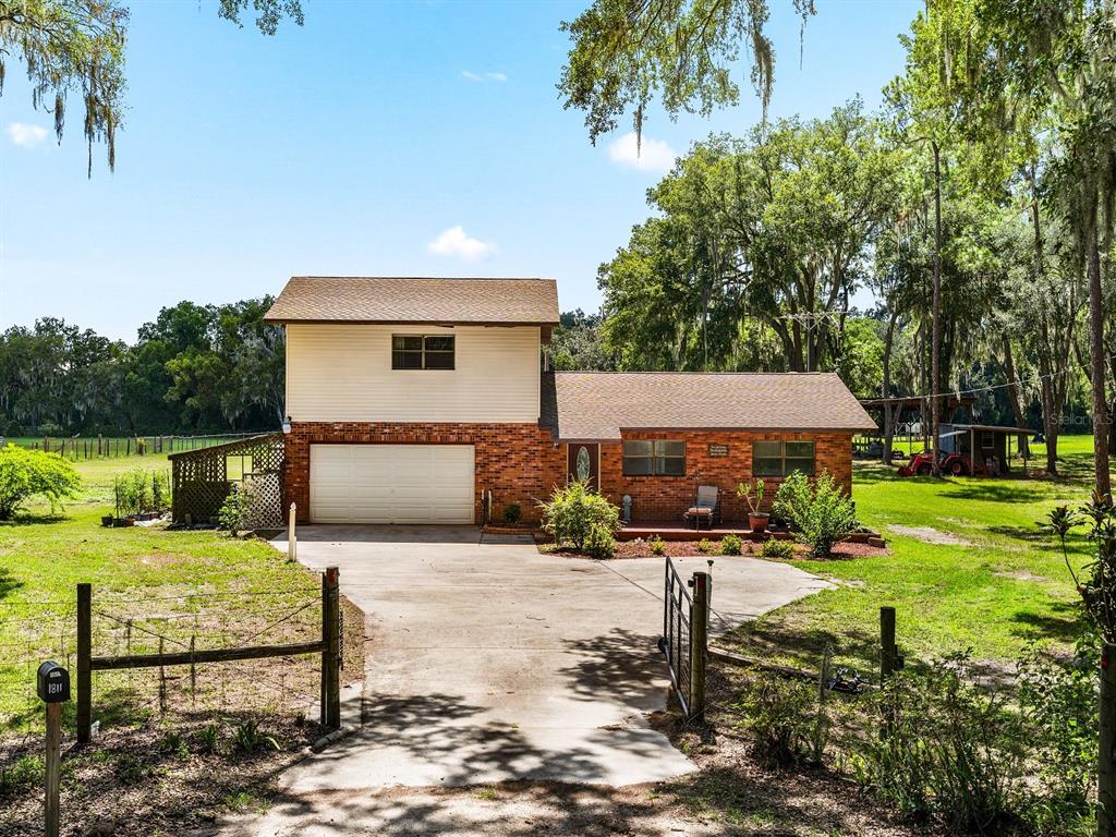 a view of a house with backyard porch and sitting area