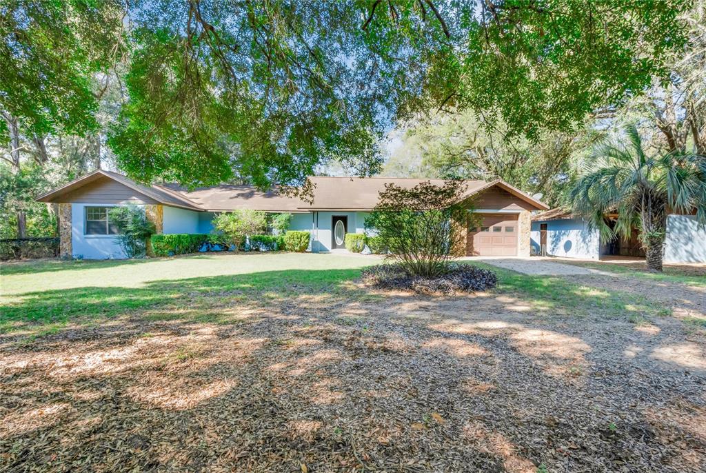 a view of house that has a yard