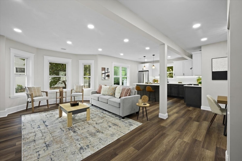 a living room with furniture and kitchen view